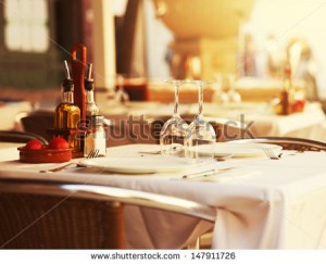 stock-photo-empty-outdoor-restaurant-table-at-sunset-147911726